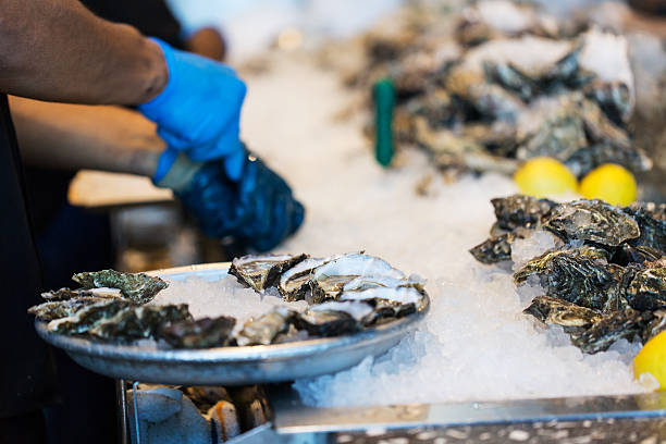 istock close-up of shucking oysters 516263058