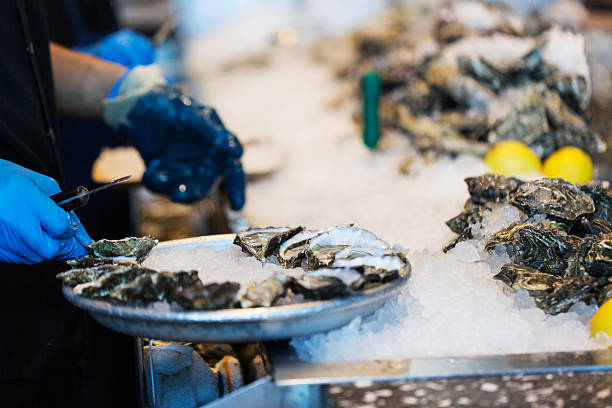 istock close-up of shucking oysters 516263076