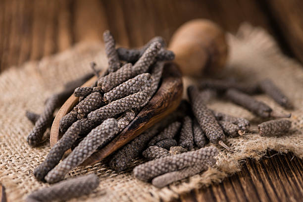 Dried Long Pepper Dried Long Pepper (selective focus) on vintage wooden background capsicum annuum longum stock pictures, royalty-free photos & images