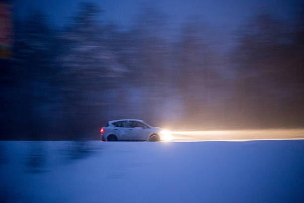 istock Car is fast riding on the road during a snowfall 516265598