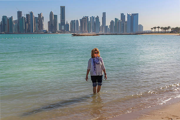 istock Barefooted woman walking in the sea 516266144