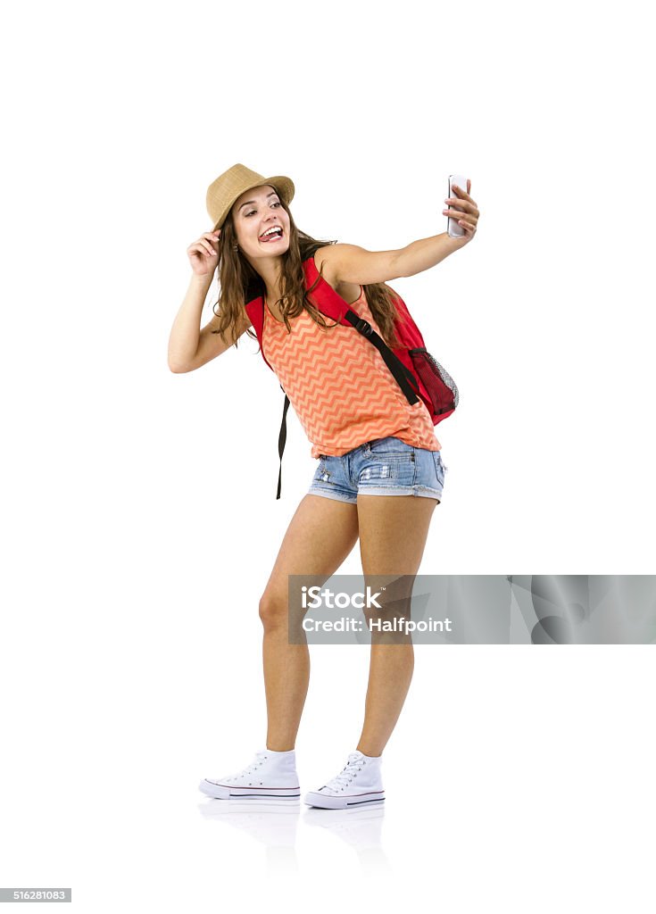 Woman tourist taking selfie Female tourist taking selfie with cell phone isolated on white background Tourist Stock Photo