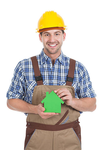 istock Confident Male Builder Holding Green House Model 516282377