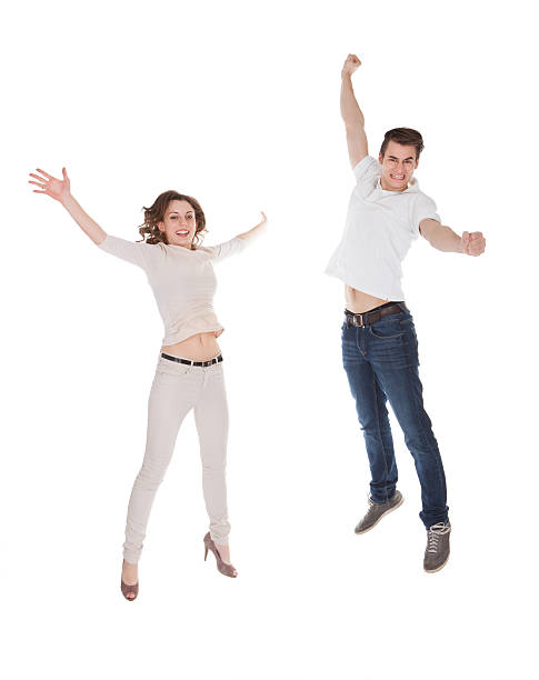 istock Couple In Casuals Jumping Over White Background 516283011