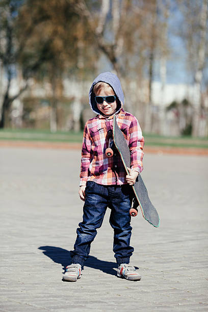 istock little boy with skateboard on the street 516283135