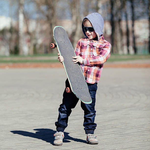 istock little boy with skateboard on the street 516283155