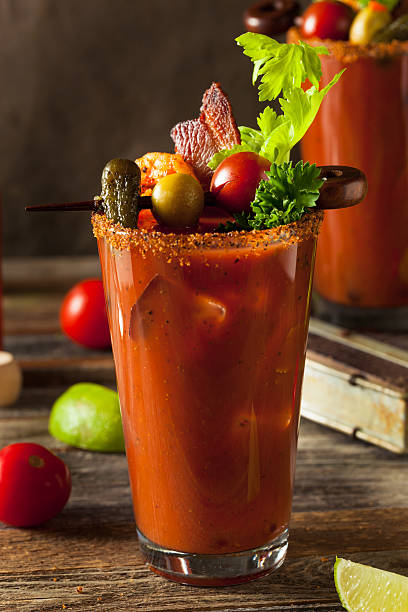 Homemade Bacon Spicy Vodka Bloody Mary Homemade Bacon Spicy Vodka Bloody Mary with Tomatos, Olive and Celery bloody mary stock pictures, royalty-free photos & images