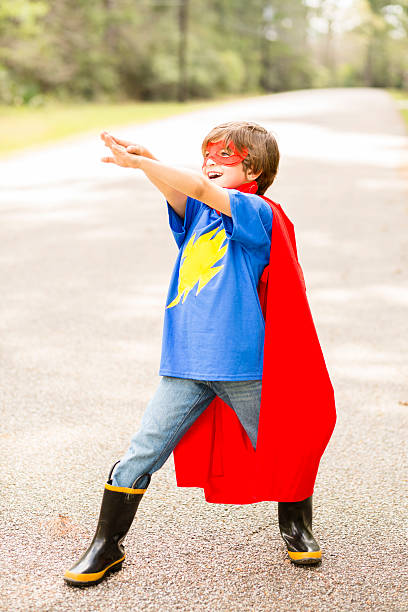 istock Little boy playing superhero outdoors. Pretend, dress up. 516283454