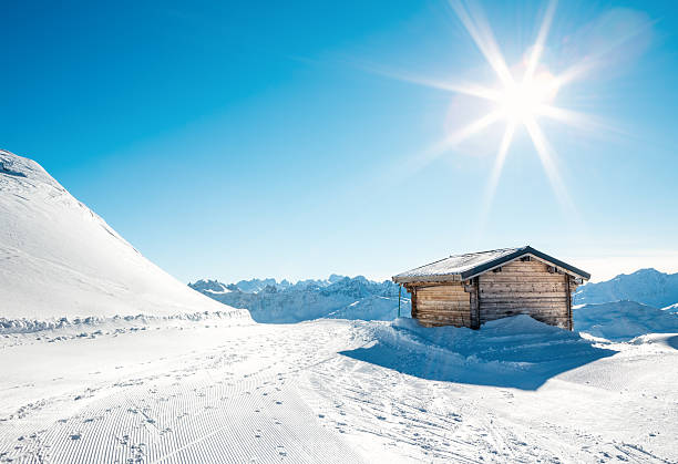 Wooden mountain cabin on a sunny winter day.