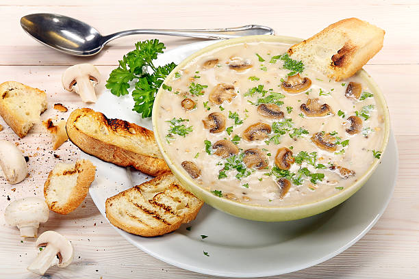 istock Mushroom soup with croutons on wooden background 516284143