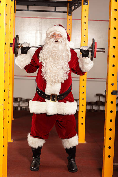 istock Santa Claus lifting weights in gym - training before Christmas 516284667