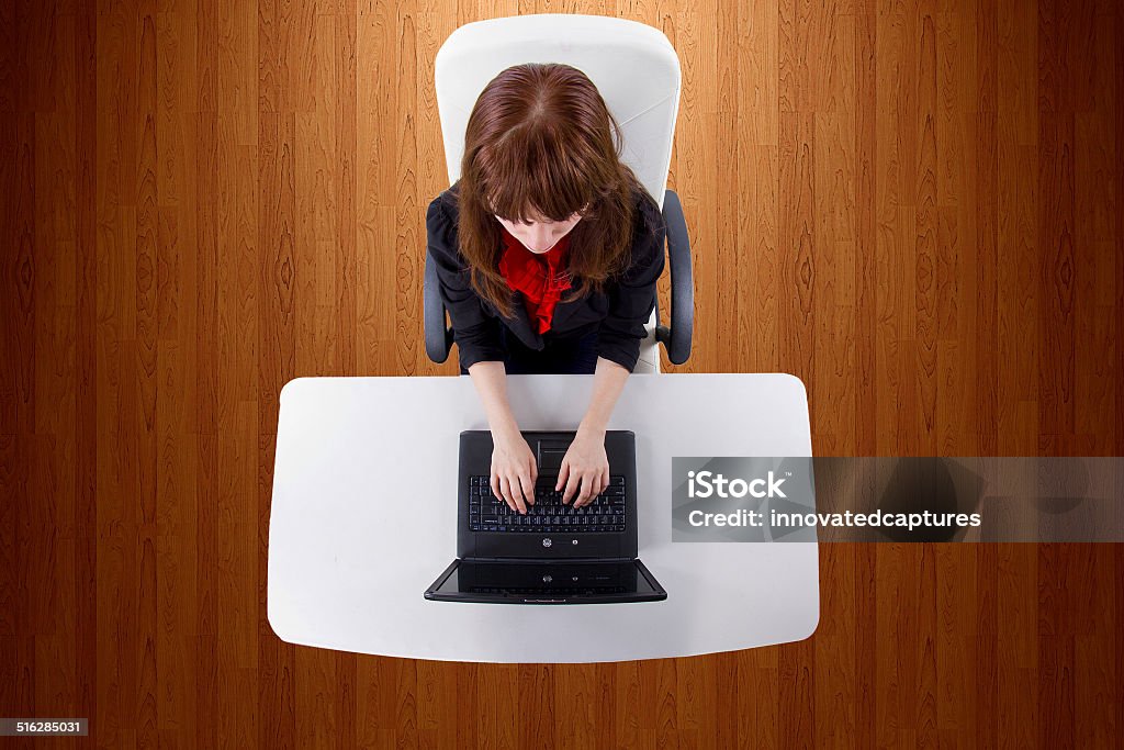 Top View of a Female Secretary on a Laptop Computer young businesswoman working on a desk with a computer Adult Stock Photo