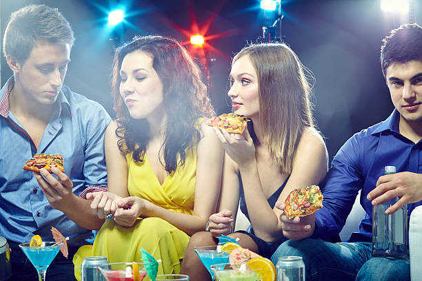 istock eating pizza in club 516285805