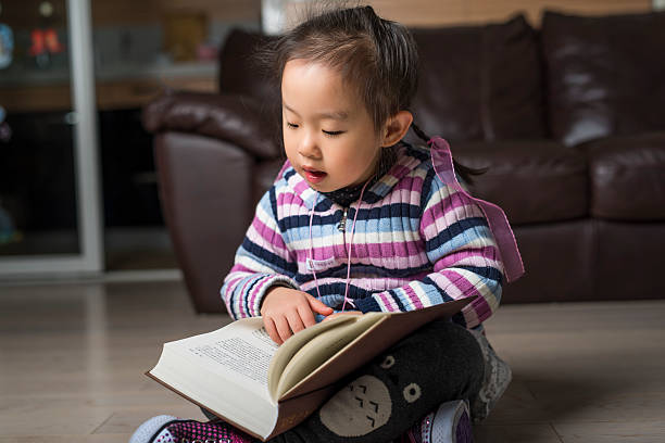 istock little smart girl reading a book 516286224