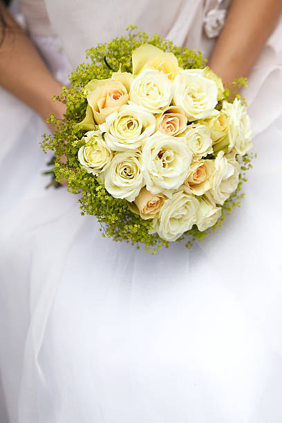 istock Wedding bunch of flowers in hands  the bride 516286339