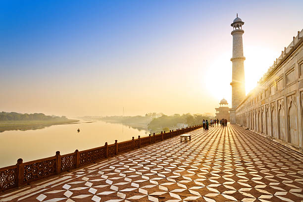 Tourists walking around the Tah Mahal at sunrise