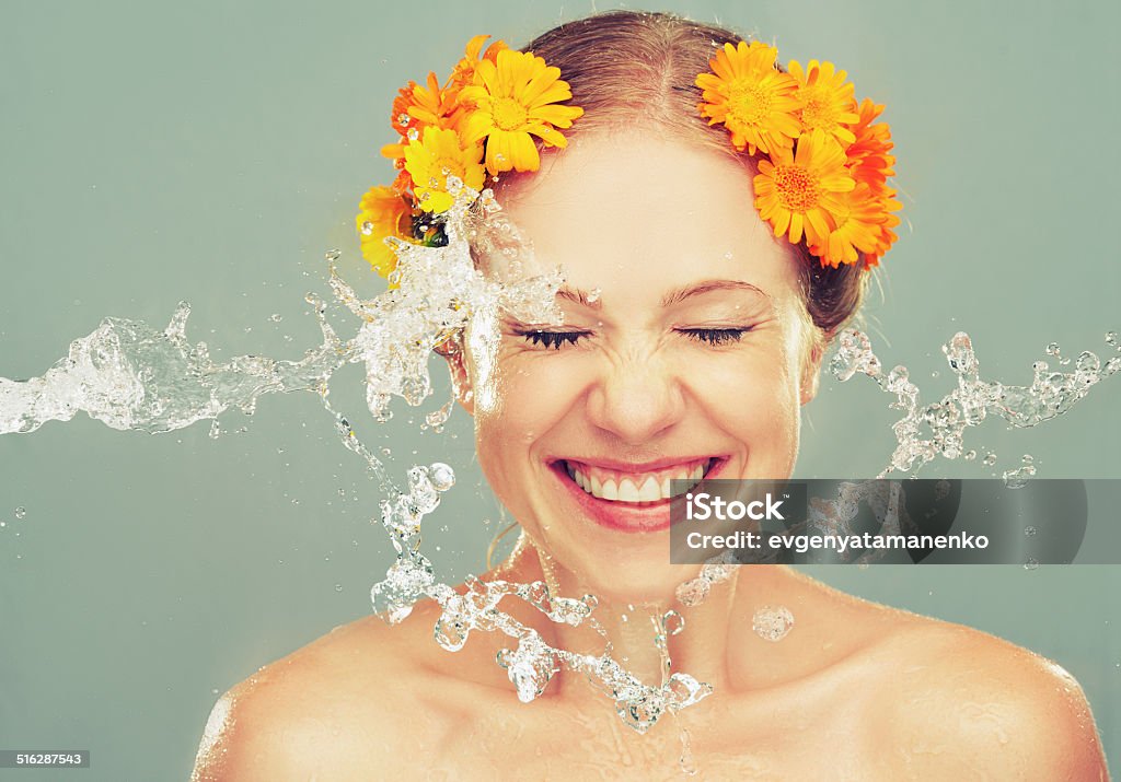 beauty laughing girl with splashes of water and yellow flowers beauty happy laughing girl with splashes of water and yellow flowers Human Face Stock Photo