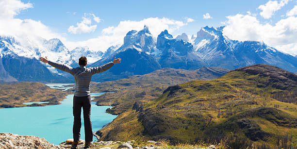 man hiking in patagonia man at mirador condor enjoying hiking and view of cuernos del paine in torres del paine national park, patagonia, chile patagonia chile photos stock pictures, royalty-free photos & images