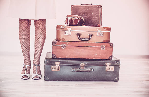 istock Woman standing beside suitcases 516290624