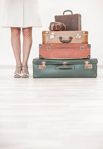 Woman standing beside suitcases