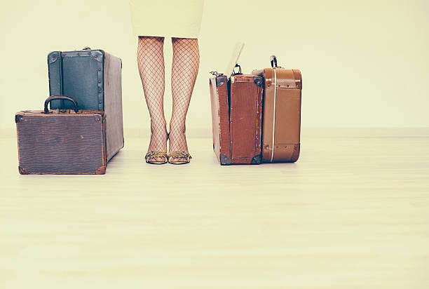 istock Woman standing beside suitcases 516291428