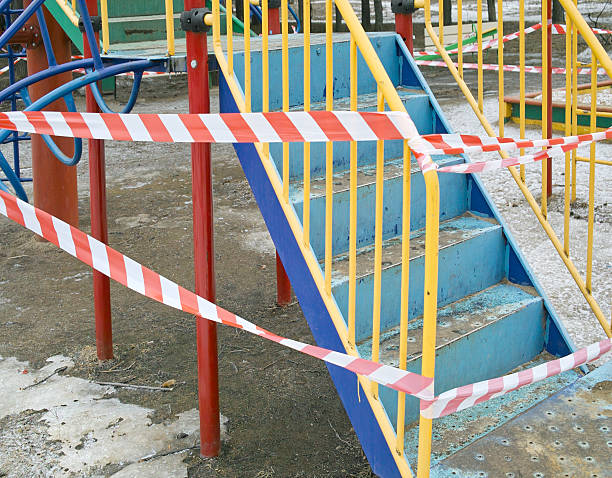 игровая площадка и предупреждения лента - swing playground empty abandoned стоковые фото и изображения