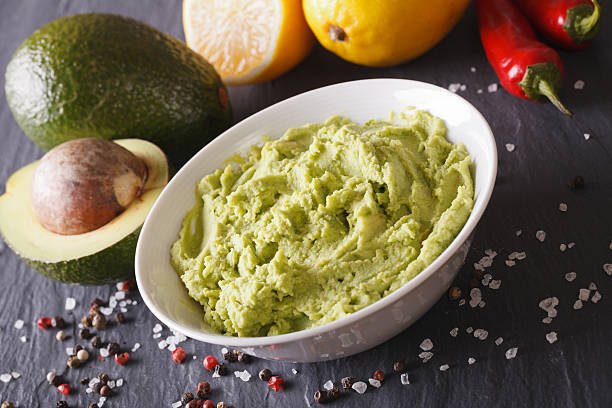 istock Traditional guacamole sauce with ingredients close-up. Horizontal 516294778