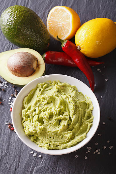 istock Traditional guacamole sauce with ingredients close-up. vertical 516295174