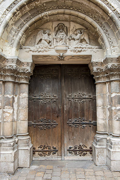 Door Church Chatellerault Wooden door of the church of Chatellerault in France with statue of Maria. chatellerault photos stock pictures, royalty-free photos & images