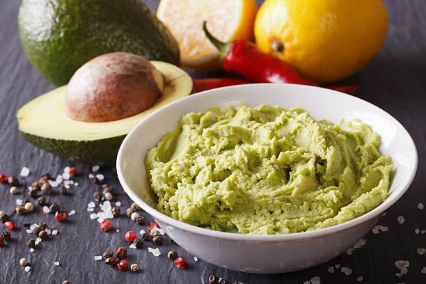 istock Fresh guacamole sauce with ingredients close-up. horizontal 516296172