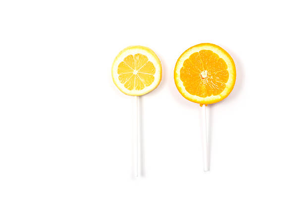 Lemon and orange like a lollipop on isolated background