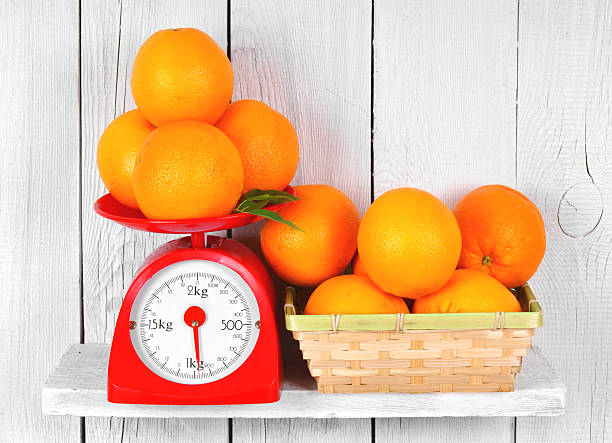 istock Orange on scales and in a basket 516313337