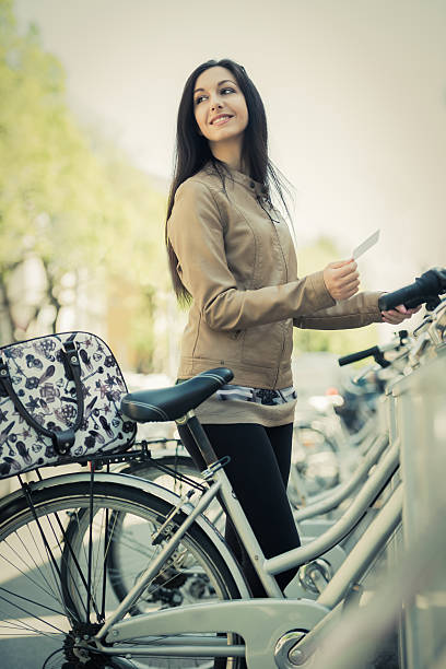 istock Young Woman Hiring A Public Bicycle 516315127