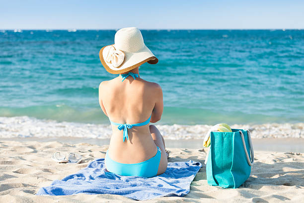 istock Woman in bikini relaxing on beach 516315499