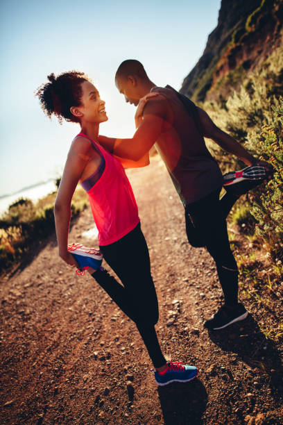 istock Happy young couple supporting together and doing stretching for running 516316186
