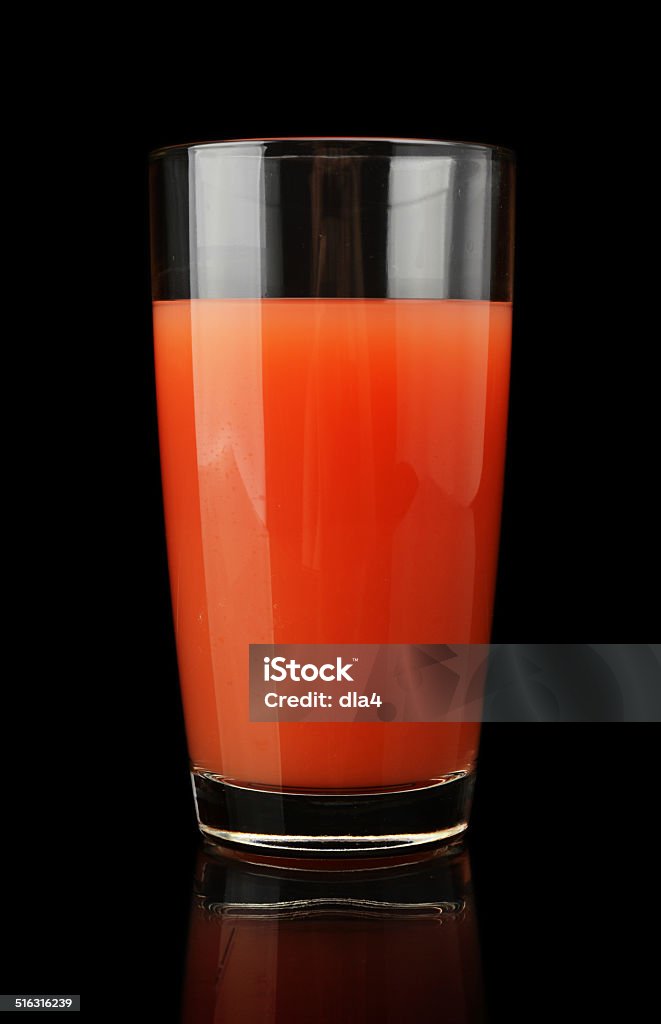 Studio shot of grapefruit juice isolated on black Studio shot of grapefruit juice isolated on black background Black Color Stock Photo