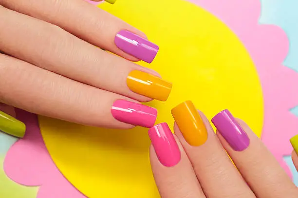 Solar manicure colored varnishes rectangular shaped nails.