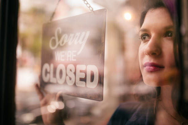 mujer de negocios doble señal de cerrado en puerta de entrada de la cafetería - clock face store time sign fotografías e imágenes de stock