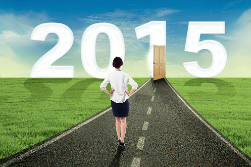Woman walking on the road towards the future 2015