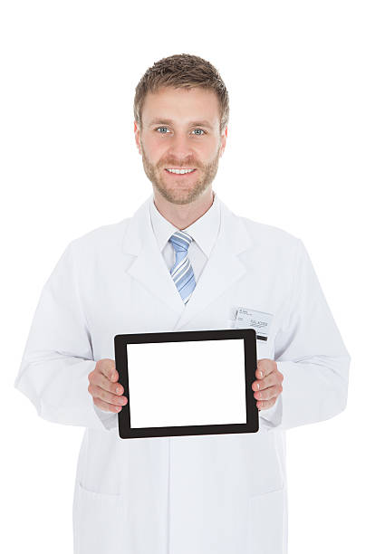 istock Smiling Young Male Doctor Displaying Digital Tablet 516318725