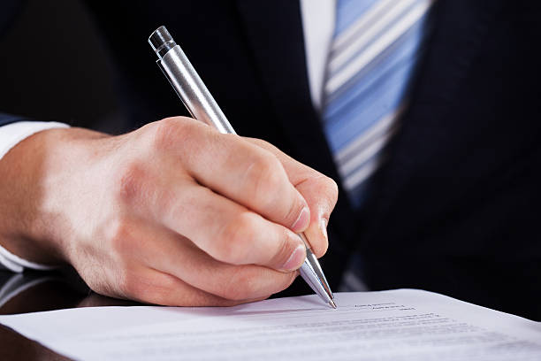 istock Businessman Signing Contract At Desk 516318745