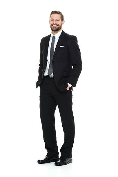 Smiling businessman looking at camera Smiling businessman looking at camerahttp://www.twodozendesign.info/i/1.png hands in pockets stock pictures, royalty-free photos & images