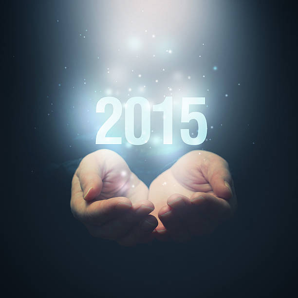 istock Open hands holding number 2015. Happy New Year. 516319783
