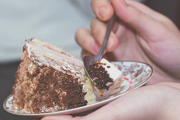 istock Girl eating birthday cake 516320122