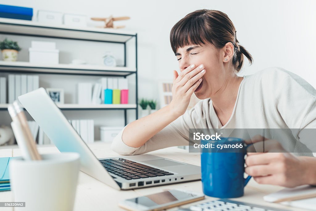 Cansado mujer en escritorio de oficina - Foto de stock de Bostezar libre de derechos