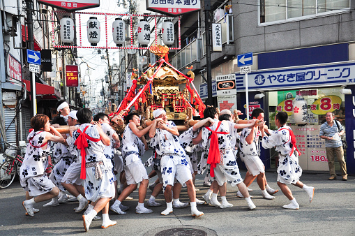 Osaka, Japan - July 25, 2012: Golden portable shrine carried and worshipped by participants of the Tenjin Matsuri Festival, the greatest festival in Osaka boasting of a history of a thousand years.