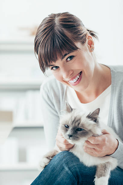 istock Woman caressing her birman cat 516320914