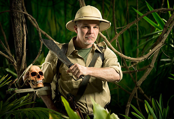 Surviving in the jungle Adventurer with colonial style survival equipment in the jungle with skull. Machete stock pictures, royalty-free photos & images