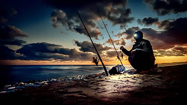 Photo of Fishing on coast at sunset time