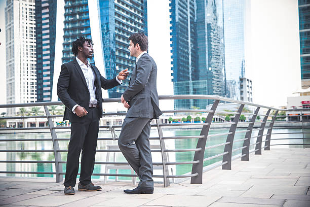 istock Two Businessmen Discussing Their Work By the Marina 516321834
